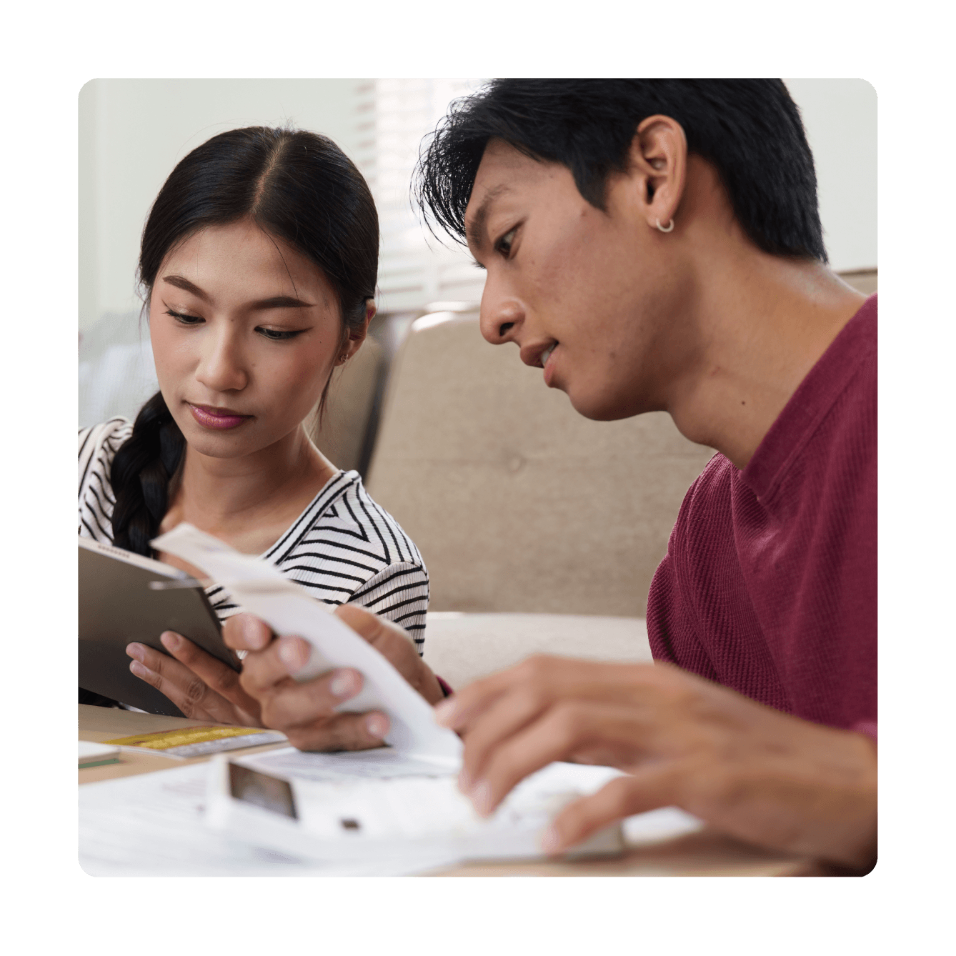 A married couple reviewing paperwork at a table