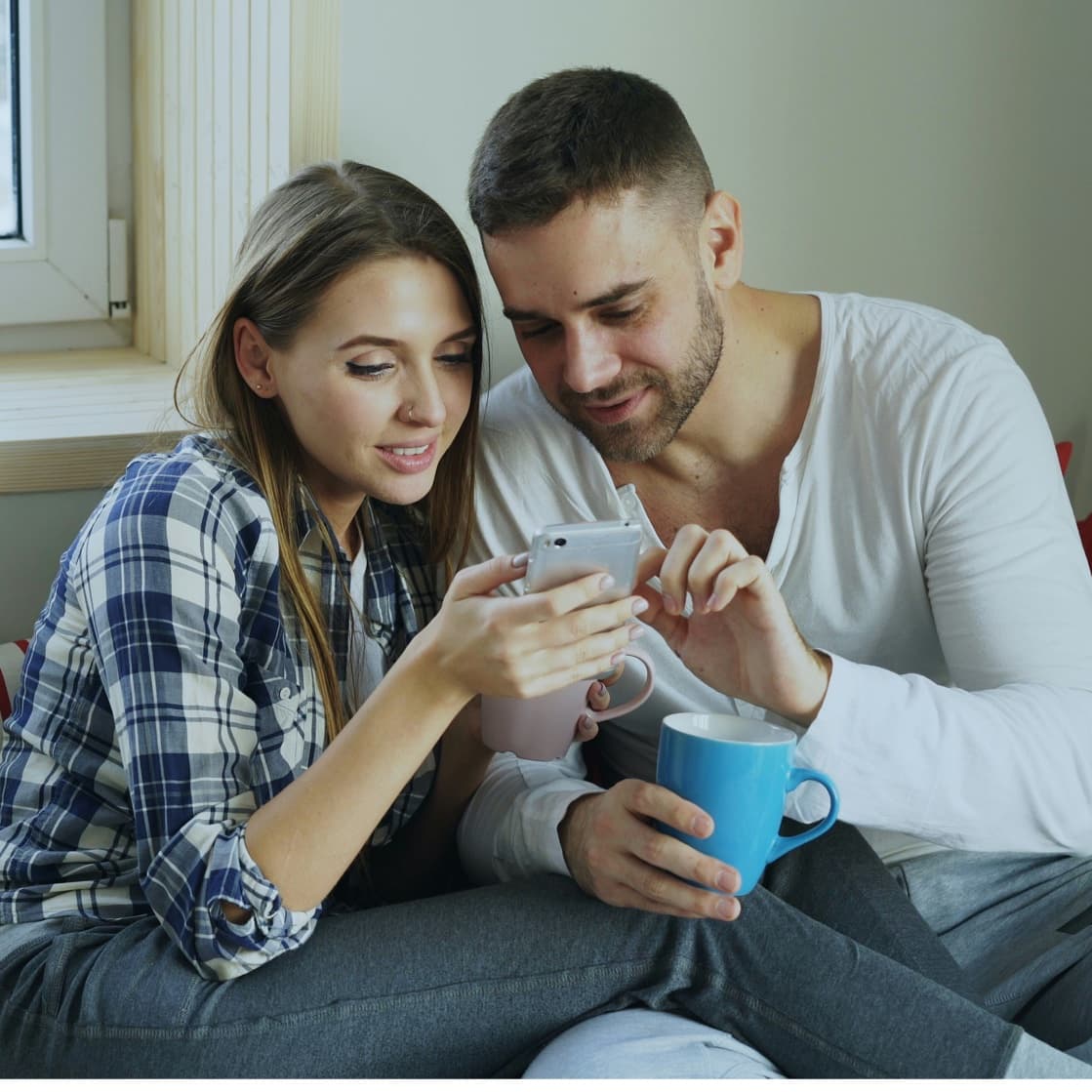 A couple talking on their sofa at home